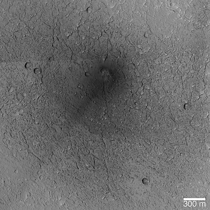 New impact site; several small craters formed in a cluster; the ejecta and disrupted surface dust are dark' a singe dark ray points toward the southwest.