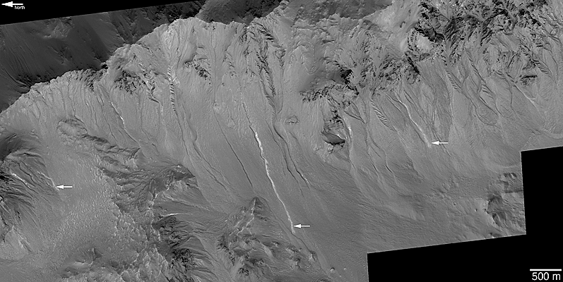 Rugged, mountainous crater wall with more than a dozen gullies, at least three of which have light-toned material on their floors and in their aprons.